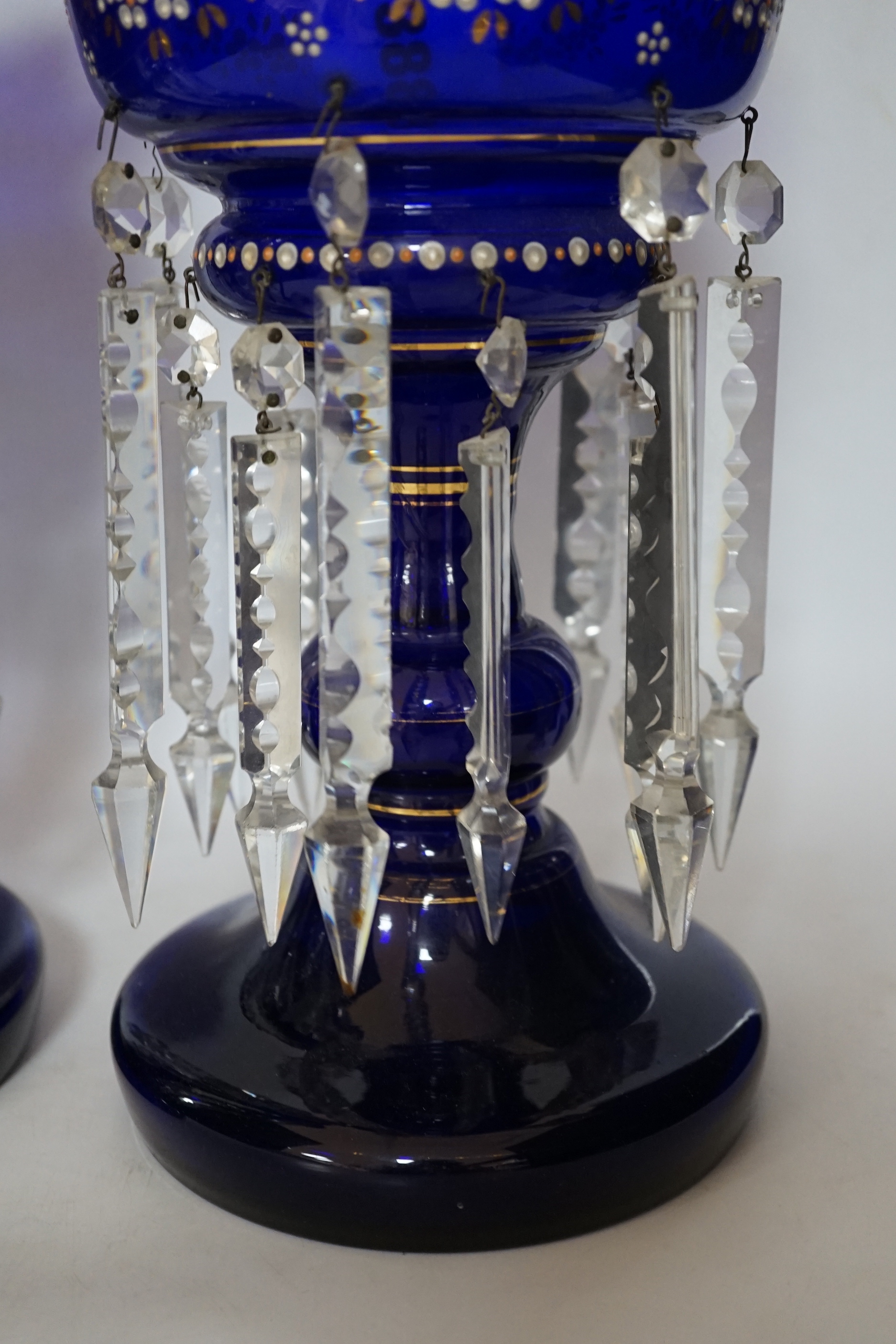 A pair of Victorian enamelled blue glass table lustres, 37cm high